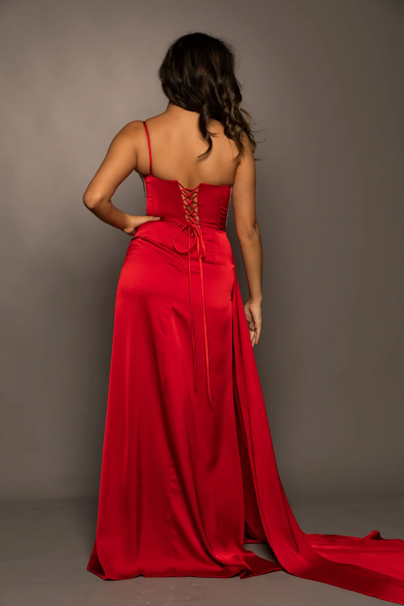 Red satin column shaped dress with one shoulder strap and high slit for hire